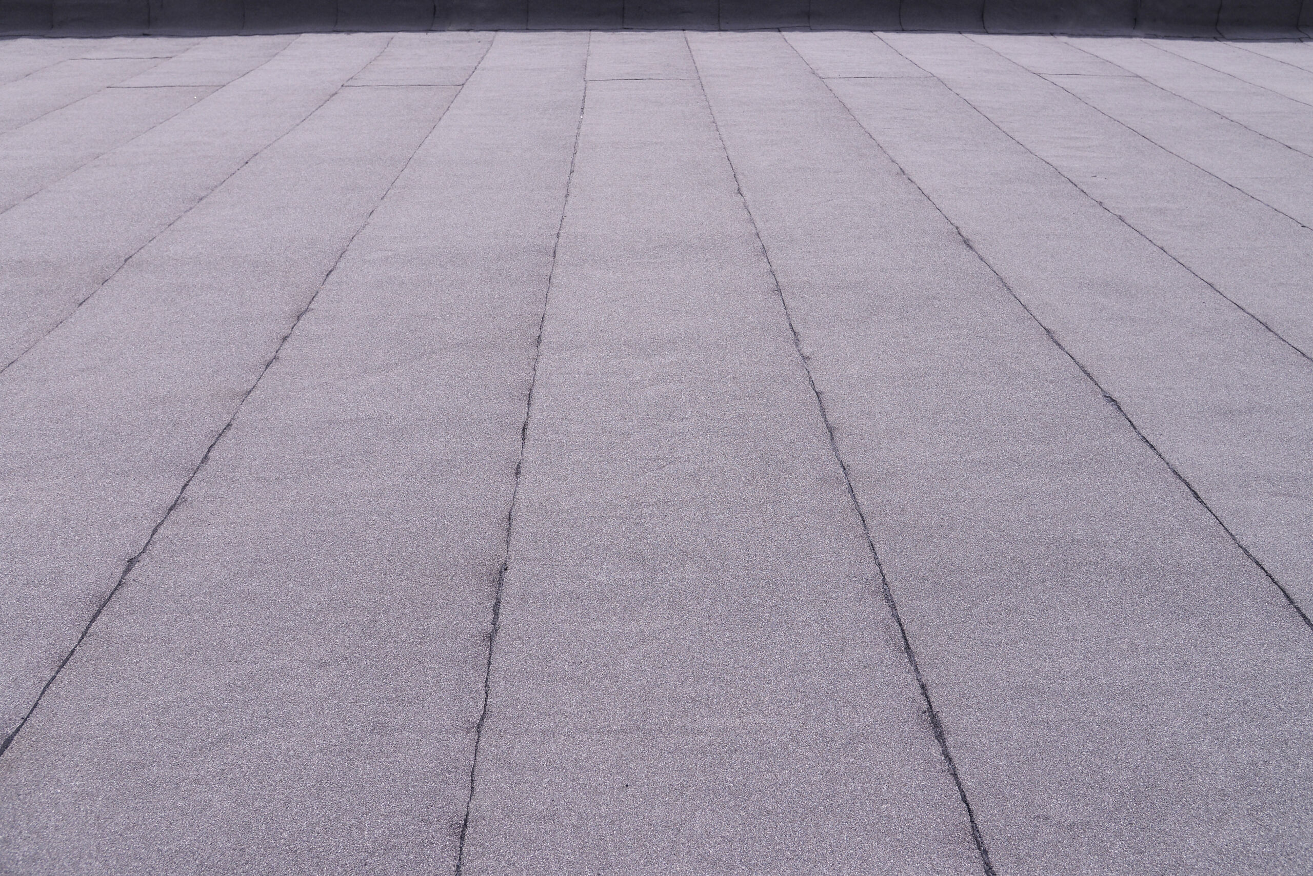 Flat surfaced roof coating. Heating and melting bitumen roofing felt background pattern. Μόνωση Οροφής/Στέγης